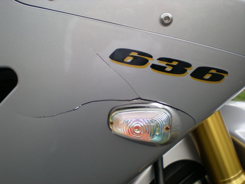 Silver motorcycle fairing with cracked paint and a 636 decal