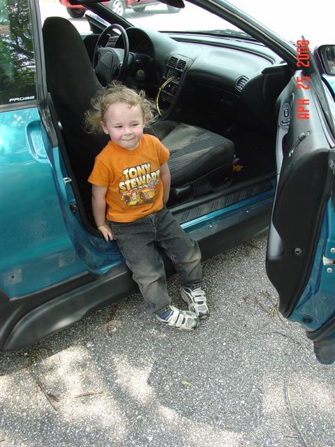 1993 Ford Probe - A child sits in the interior of a 1993 Ford Probe.