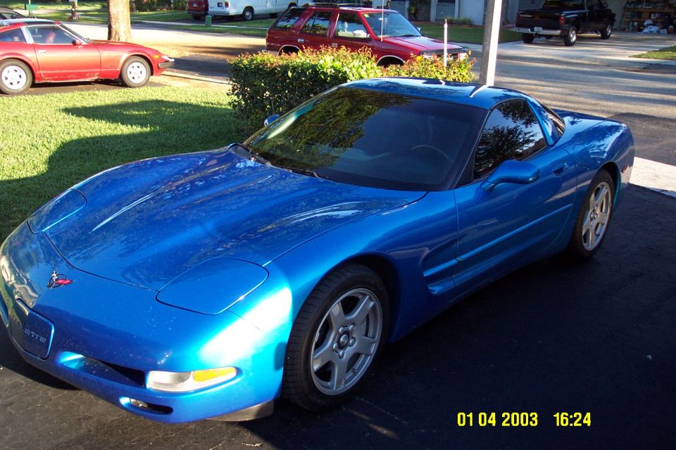 Blue C5 Corvette coupe parked in a driveway, front three-quarter view, dated 01 04 2003