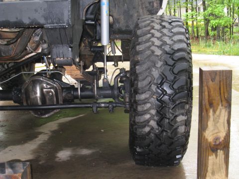 1996 Ford Bronco - The vehicle's suspension system and large tire are visible in this close-up shot.