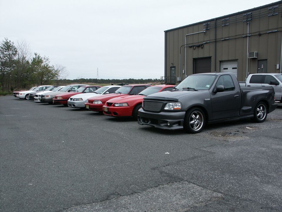 Dark gray 2001 Ford F-150 SVT Lightning pickup truck, front 3/4 view, parked in front of a building