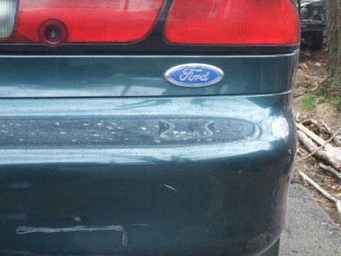 1997 Ford Probe - The rear of a 1997 Ford Probe, the Ford emblem and a red taillight assembly.