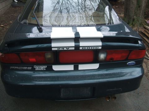 1997 Ford Probe - The rear of a dark green 1997 Ford Probe is shown with white racing stripes and "24 V DOHC" badging.