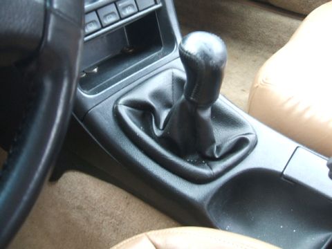 1997 Ford Probe - Interior view of a 1997 Ford Probe, focusing on the manual transmission shifter and surrounding center console area.