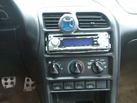 1997 Ford Probe - Interior view of a car's dashboard, showing the stereo and climate control knobs.