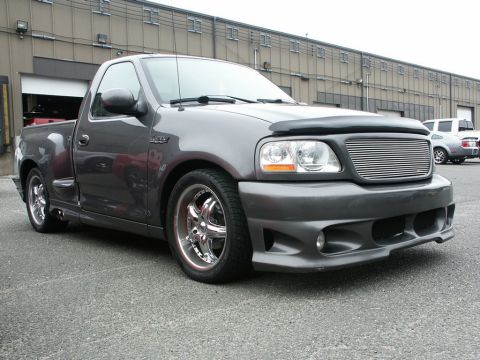 2001 Mercury Grand Marquis - Gray Ford F-150 Lightning pickup truck with custom grille and wheels.