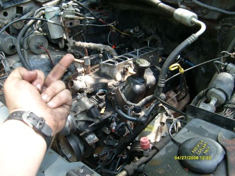 1992 Ford Bronco - A close-up view of a vehicle's engine bay, showing mechanical components and wiring.