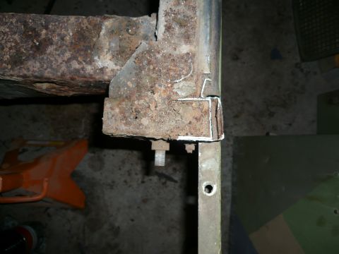 1974 Land Rover Land Rover - Close-up of a corroded metal frame section, possibly part of a vehicle chassis.