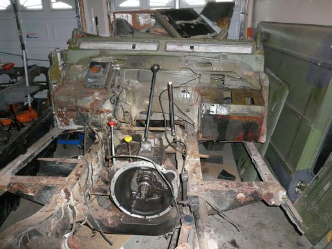 1974 Land Rover Land Rover - The vehicle's frame and drivetrain components are exposed during a rebuild process.