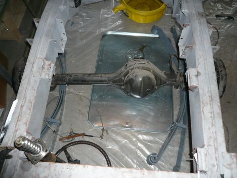 1974 Land Rover Land Rover - The rear axle and leaf springs are visible on the chassis of a vehicle undergoing restoration.