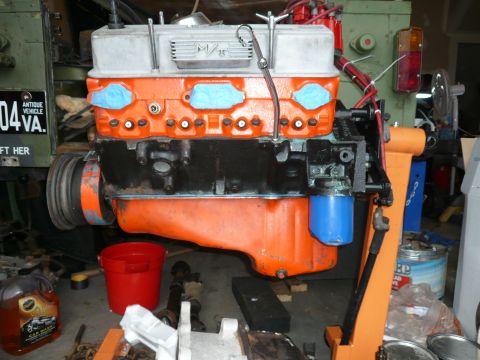 1974 Land Rover Land Rover - An engine is shown on a stand, with various tools and parts around it.