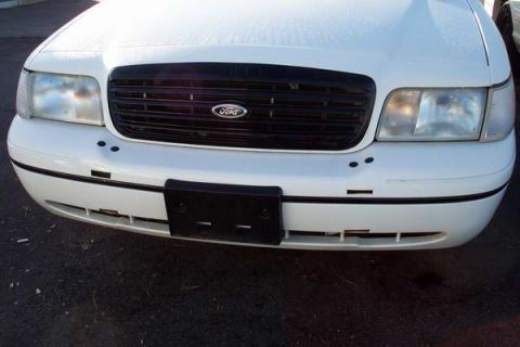 1999 Ford Crown Victoria - Front view of a white 1998 Ford Crown Victoria, its distinctive black grille and headlights.