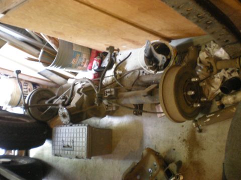 1993 Ford Bronco - Rear axle assembly with drum brakes and suspension parts, likely for a truck or SUV.