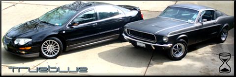 2002 Chrysler 300M - A 1967 Ford Mustang is parked next to a black Chrysler 300M on a paved surface.