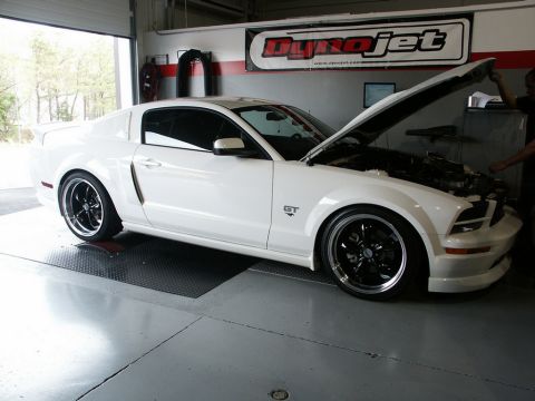 2001 Mercury Grand Marquis - White Ford Mustang GT on a dynamometer with hood open. Dynojet banner visible on the wall.