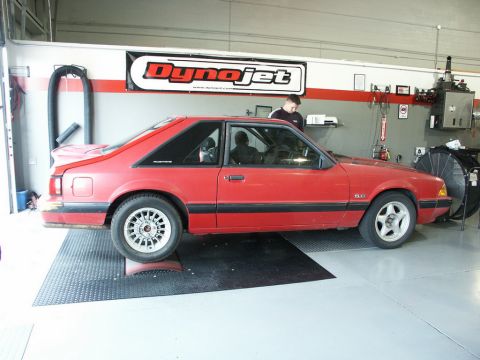 2001 Mercury Grand Marquis - A red coupe is positioned on a dynamometer in a workshop, with a 'Dynojet' banner overhead.