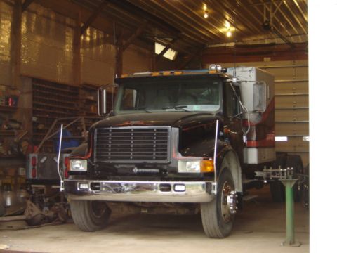 1992 Ford Bronco - Front view of an International truck cab inside a workshop.