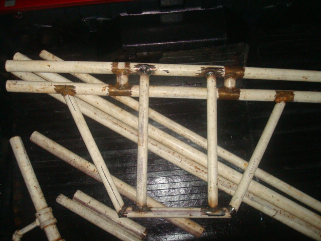Pile of white painted metal pipes welded together in a frame structure