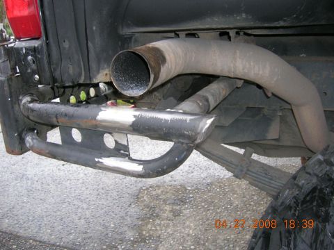 1996 Ford Bronco - Close-up of a custom rear bumper and exhaust system on a vehicle.