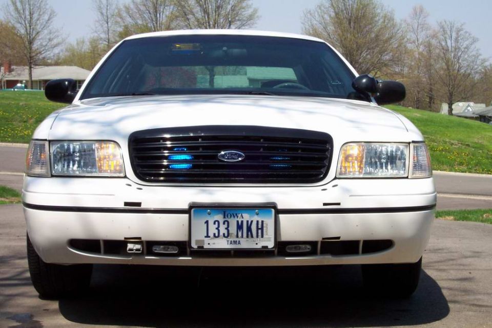Head-on front of a white Ford Crown Victoria with Iowa plate 133 MKH