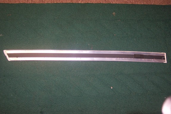 Silver and black door trim piece
