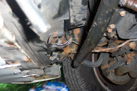1996 Ford Crown Victoria - Close-up of vehicle undercarriage, focusing on suspension and tire details.