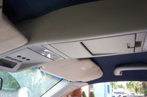 1996 Ford Crown Victoria - Interior view of a car's overhead console and sun visor, showing storage compartments and lighting.