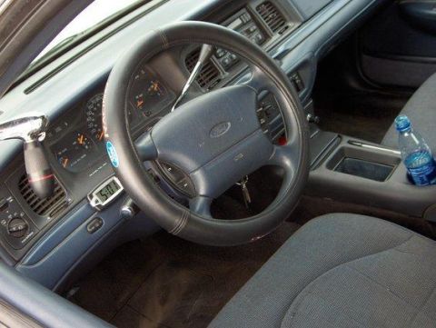 1996 Ford Crown Victoria - Interior view of a 1996 Ford Crown Victoria, focusing on the dashboard and driver's area.