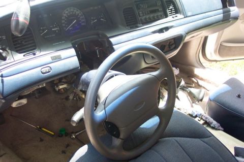 1996 Ford Crown Victoria - The interior of a 1996 Ford Crown Victoria shows a disassembled dashboard and steering wheel.