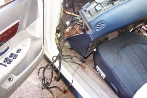 1996 Ford Crown Victoria - Interior of a car with dashboard removed and wiring exposed, likely undergoing repairs or modifications.