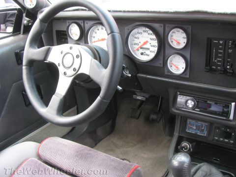 1968 Ford Mustang - The interior dashboard features aftermarket gauges and a custom steering wheel, indicating modifications to the vehicle.