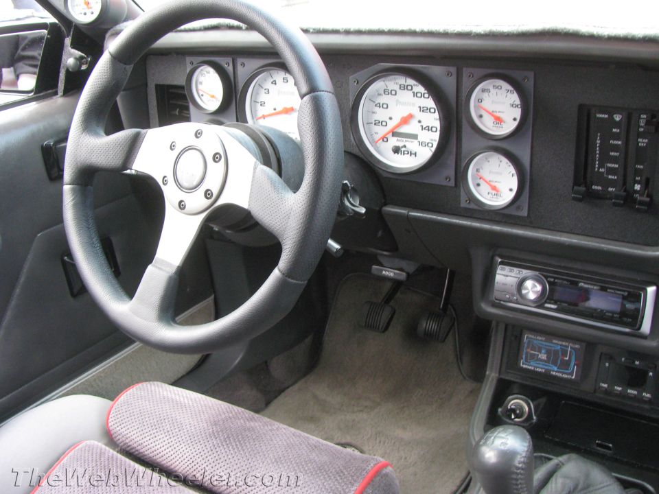 Interior dashboard with aftermarket gauges and a aftermarket steering wheel