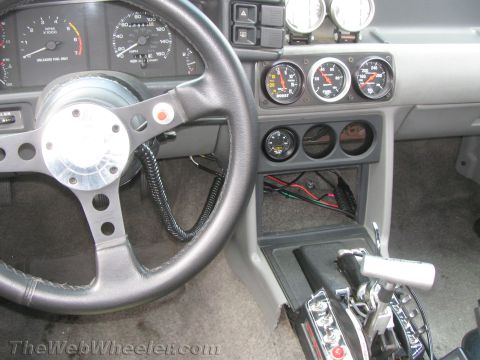 1968 Ford Mustang - Aftermarket gauges and shifter installed in a car's interior.