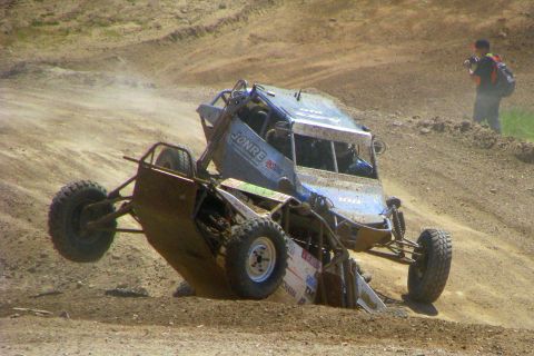 2008 Ford Bronco - Two off-road vehicles collide during a race, creating a dramatic scene on the dirt track.