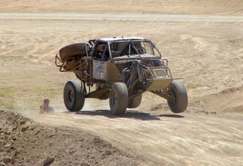 2008 Ford Bronco - A custom off-road buggy, marked with number 107, takes flight over a dusty track.