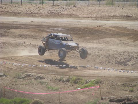 2008 Ford Bronco - An off-road buggy takes flight during a race on a dirt track.