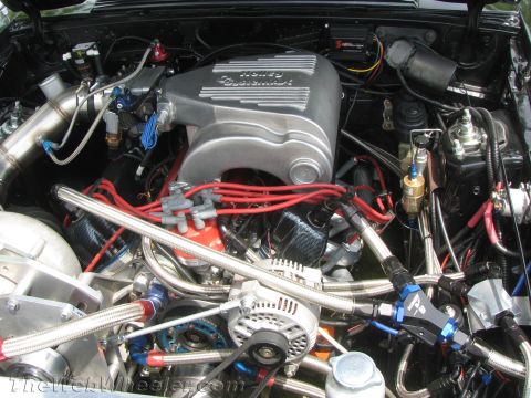 1968 Ford Mustang - Close-up view of a modified V8 engine bay, custom fuel lines and polished components.