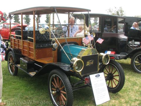 1968 Ford Mustang - A Ford Model T touring car with a wooden body and canopy is displayed at an outdoor event.