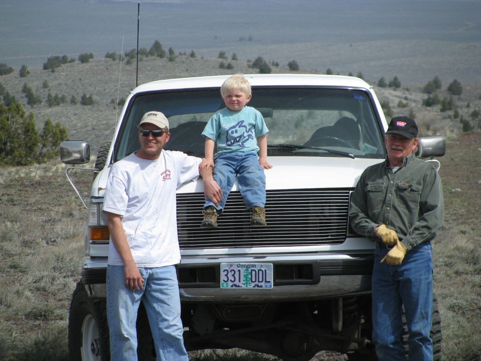 White Ford Bronco front view with billet grille, Oregon plate 331 DDL, child on hood