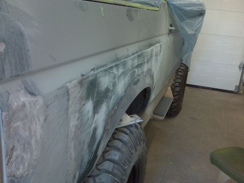 1996 Ford Bronco - Photograph of a truck body panel being prepped and primed during restoration, not a technical document.