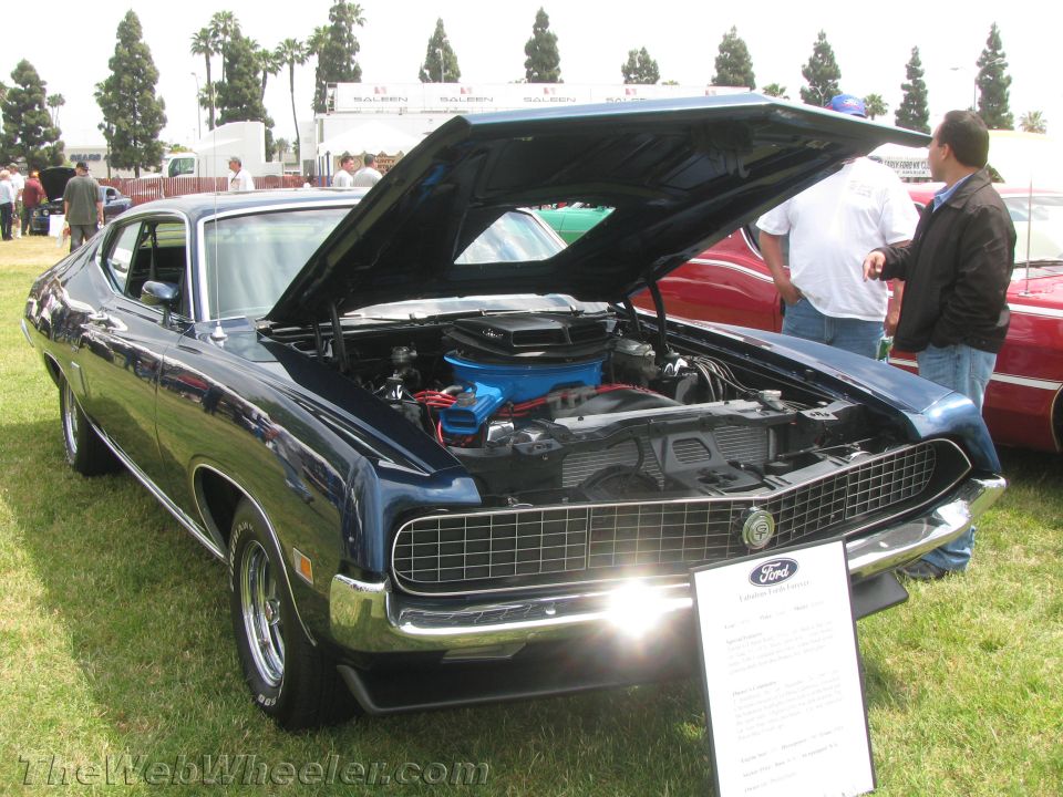 Dark blue 1970 Ford Torino with hood open at a car show
