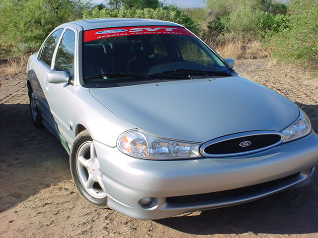 Silver Ford Contour sedan with SVT windshield banner on dirt lot
