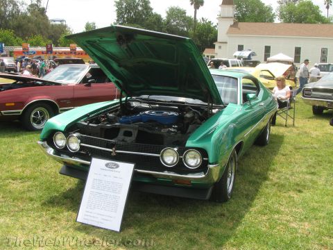 1968 Ford Mustang - Photograph of a green Ford Torino with hood raised and an information placard at a car show.