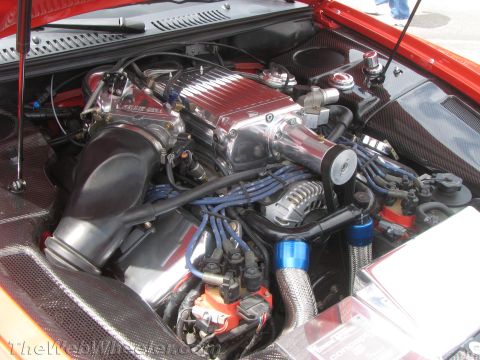 1968 Ford Mustang - Photograph of a supercharged engine bay with blue spark-plug wires and carbon-fiber surround.