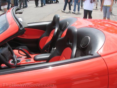 1968 Ford Mustang - Photograph of a red custom roadster interior with two-tone red and black bucket seats.