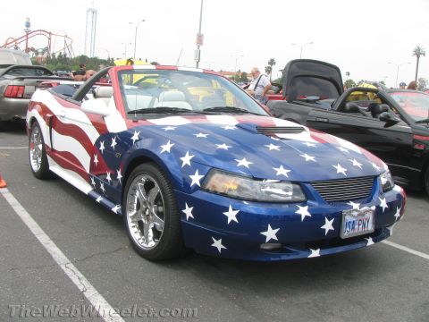 1968 Ford Mustang - Photograph of a Mustang GT convertible with an American-flag paint scheme at a show.