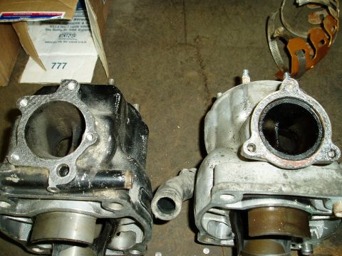 2000 Ford E350 - Two engine cylinders are shown side-by-side, with one being black and the other silver. A cardboard box with text that includes "KING" and…