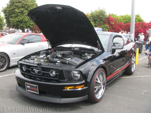 1968 Ford Mustang - Black Ford Mustang with hood open, parked next to a silver Mustang GT.