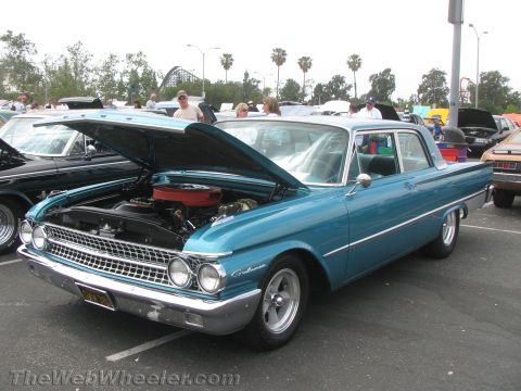 1968 Ford Mustang - This blue sedan, identified by its "Galaxie" script, is displayed with its hood open, revealing the engine bay.