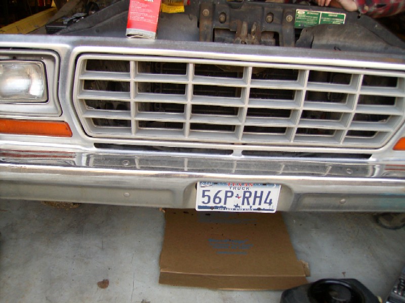 Front of a classic pickup truck with a chrome bumper and grille, showing a Texas license plate.
